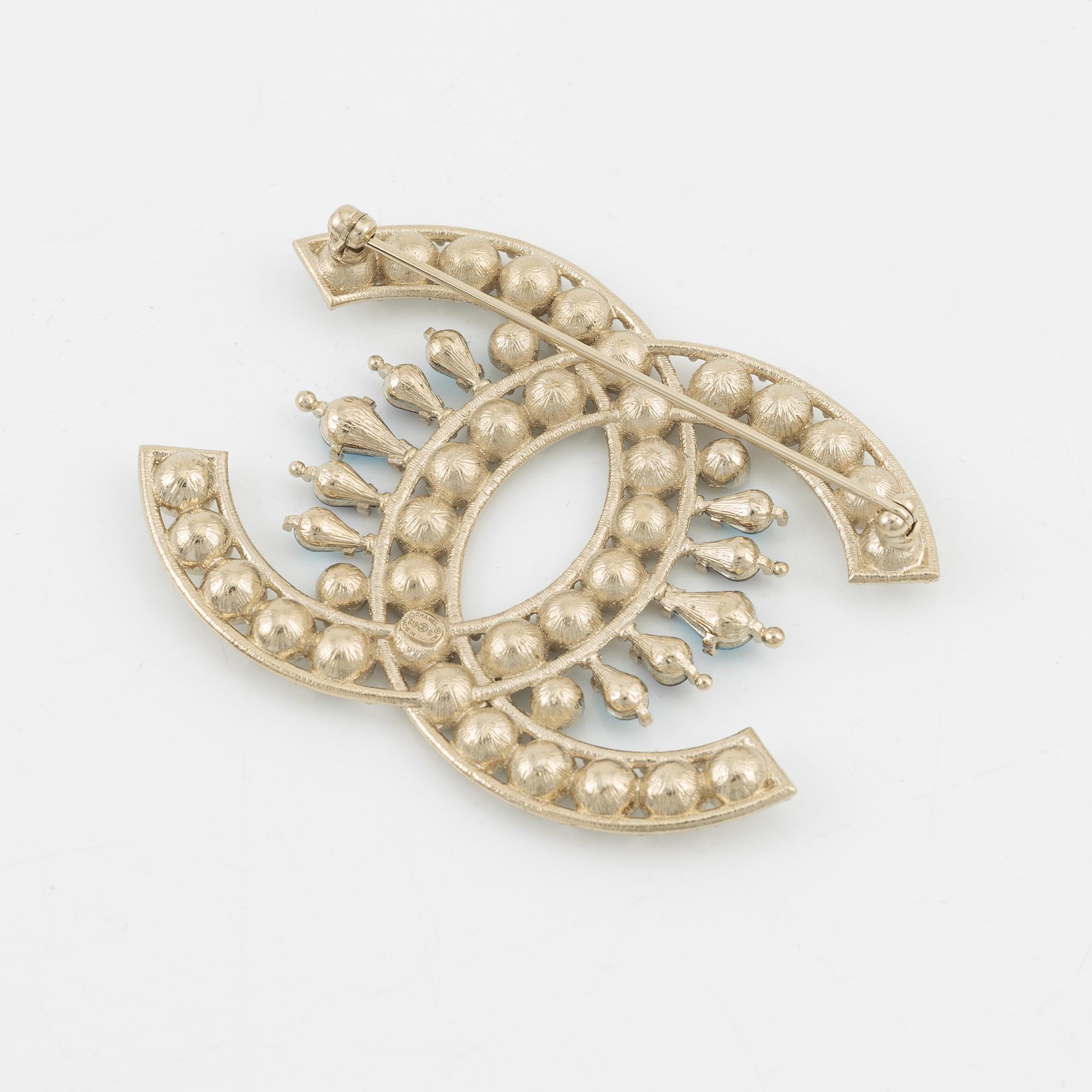 Chanel, a silvermetal, rhinestone and crystal brooch, 2019.