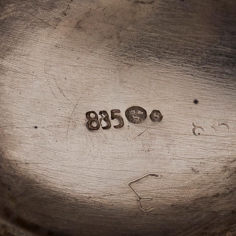 A three-piece silver coffee service, Swedish import marks. Silver sugar tongs, T.K. Alenius Vasa 1953.