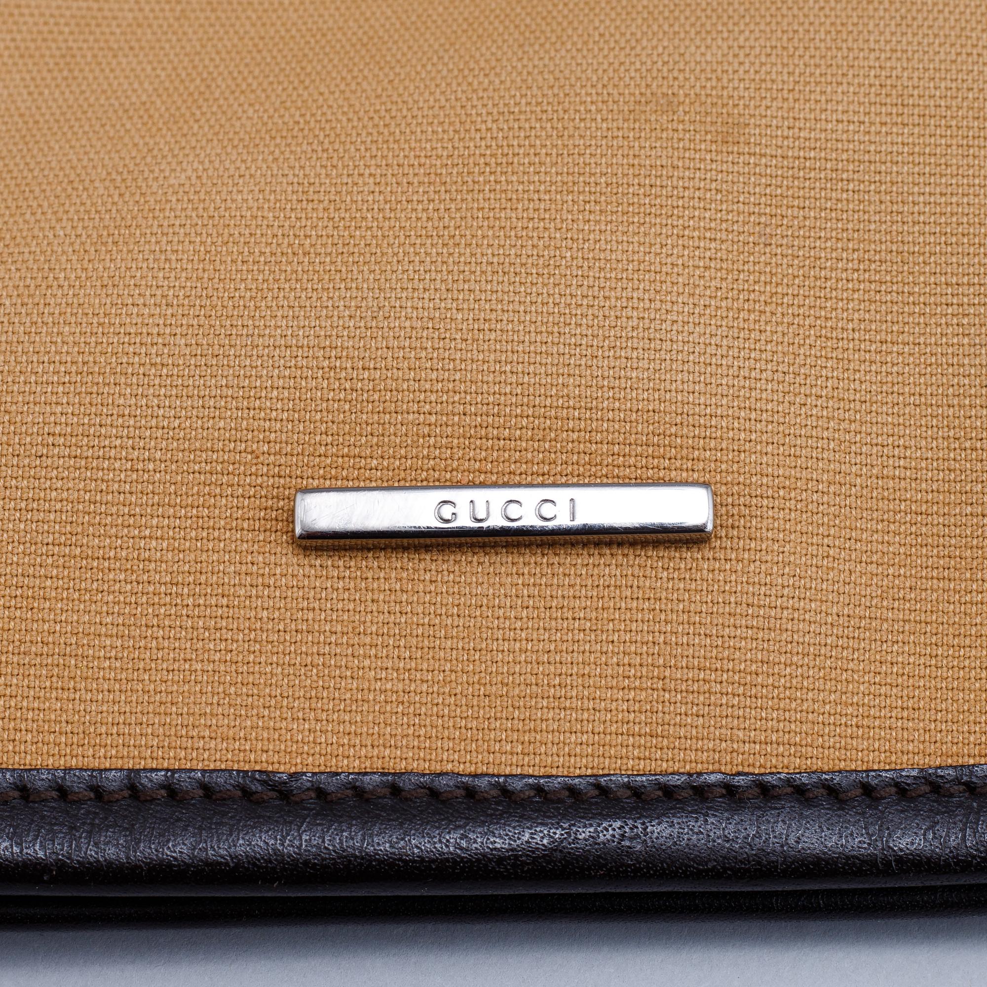 Gucci, a canvas handbag.