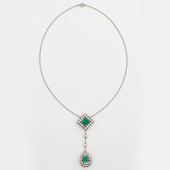 A necklace set with two faceted emeralds and old-cut diamonds.