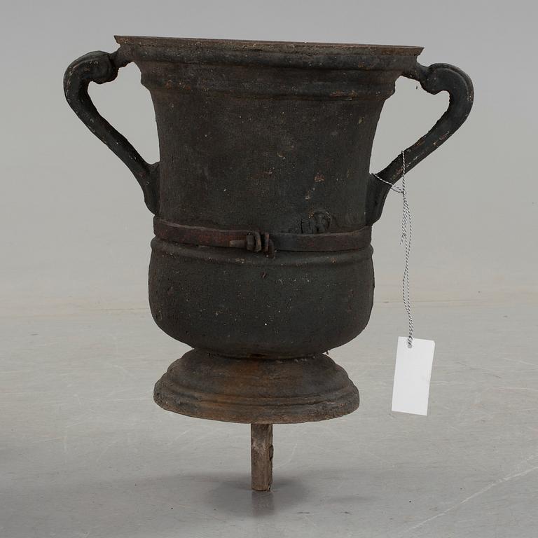 A cast iron green garden urn, dated 1791.