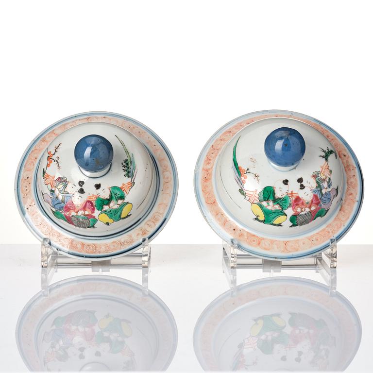 A pair of famille rose 'ladies and boys' vases with covers, late Qing dynasty.