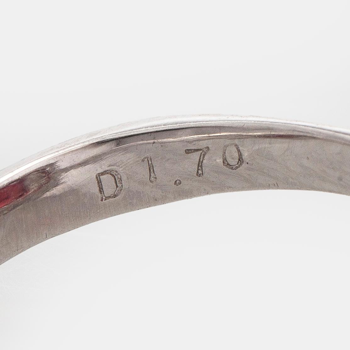 A platinum ring with spinel and brilliant cut diamonds.