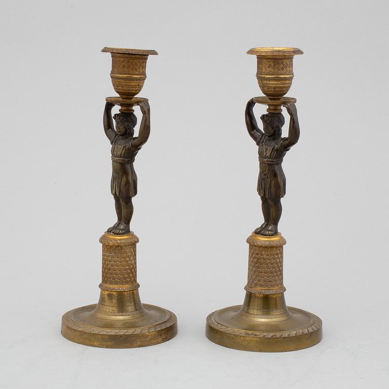 A pair of late Gustavian bronze candlesticks from around year 1800.