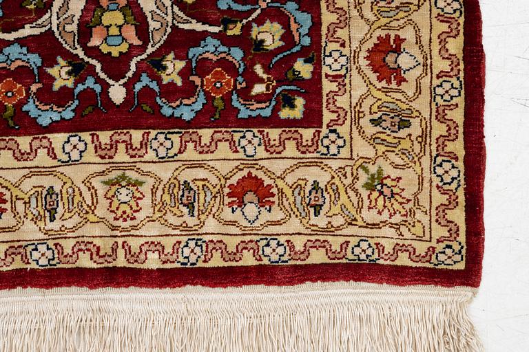 A silk and metal Hereke rug, West Anatolia, c. 58 x 39 cm.