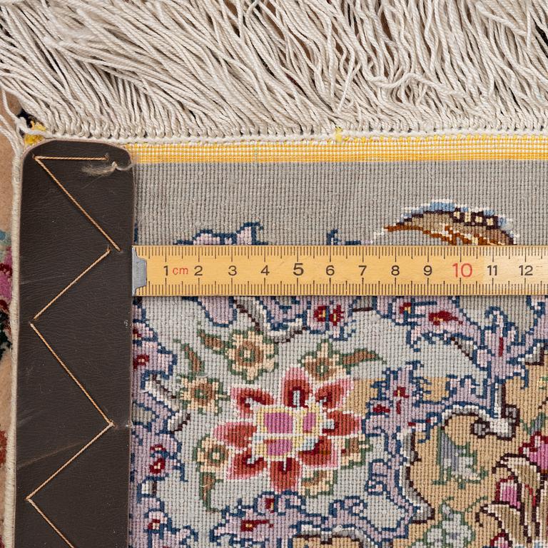A Tabriz carpet, part silk, approx. 367 x 250 cm.