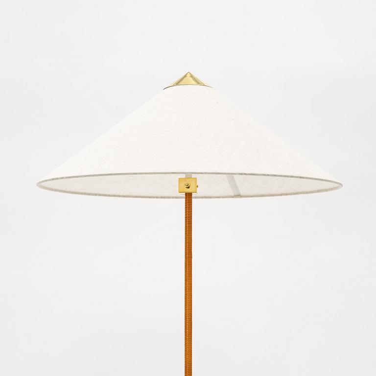 Paavo Tynell, A model 9602 brass and rattan floor lamp with canvas shade from Gubi,