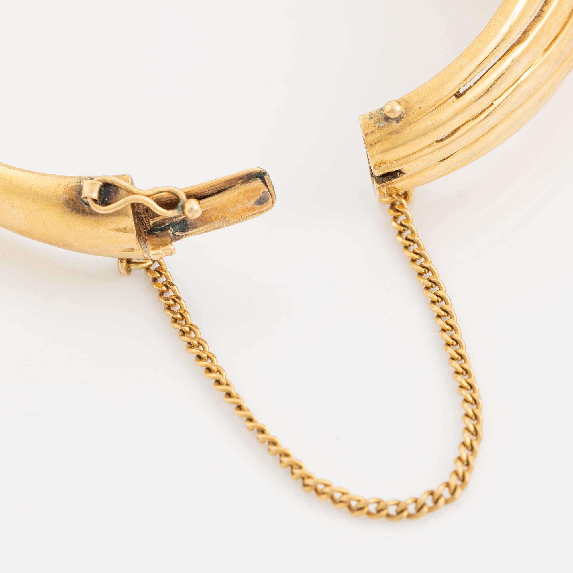 Brilliant cut diamond gold bangle.