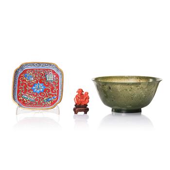 918. A Chinese enamel on copper coaster, a green stone bowl and a small stone figure, China, Qing dynasty and 20th century.