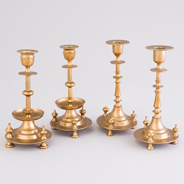 Four Russian brass candlesticks, two marked Pimenov, around 1900.