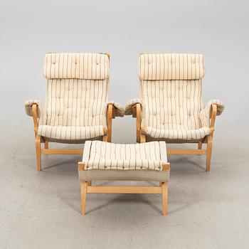 A pair of 'Pernilla' easy chairs and a stool by Bruno Mathsson for Dux, end of the 20th Century.