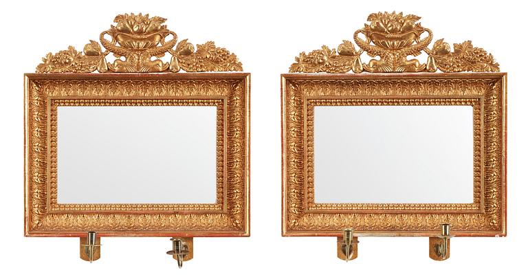 A pair of Swedish Empire first half 19th century two-light girandole mirrors.