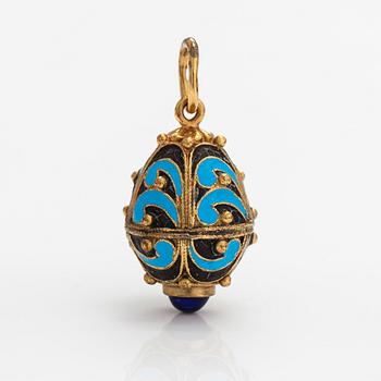 A gilded brass pendant with enamel and glass stones.