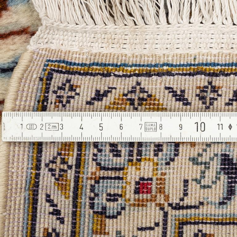 A Keschan carpet, signed, c. 350 x 245 cm.