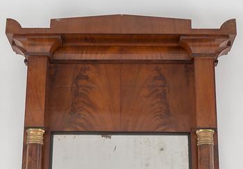 A swedish empire mirror and console table. First half of the 19th century.