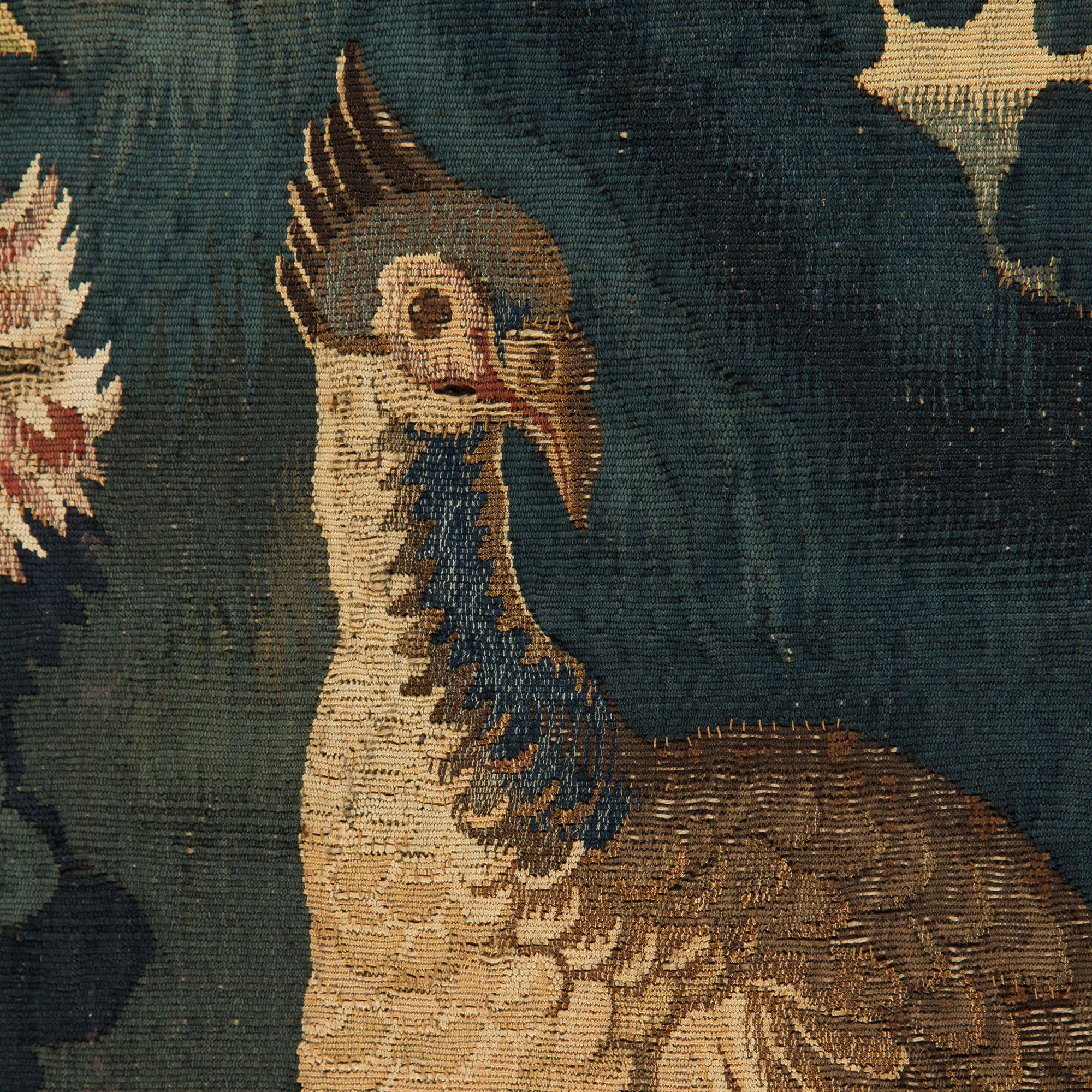 A FRAGMENT O A TAPESTRY. Tapestry weave. Verdure. Around 97 x 166 cm . Flanders,  the fist half of the 18th century.