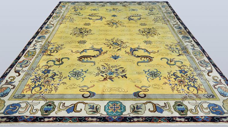 A Tabriz carpet, signed, approx. 388 x 280 cm.