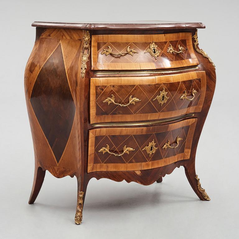 A Swedish rosewood-veneered Rococo chest of drawers, later part of the 18th century.