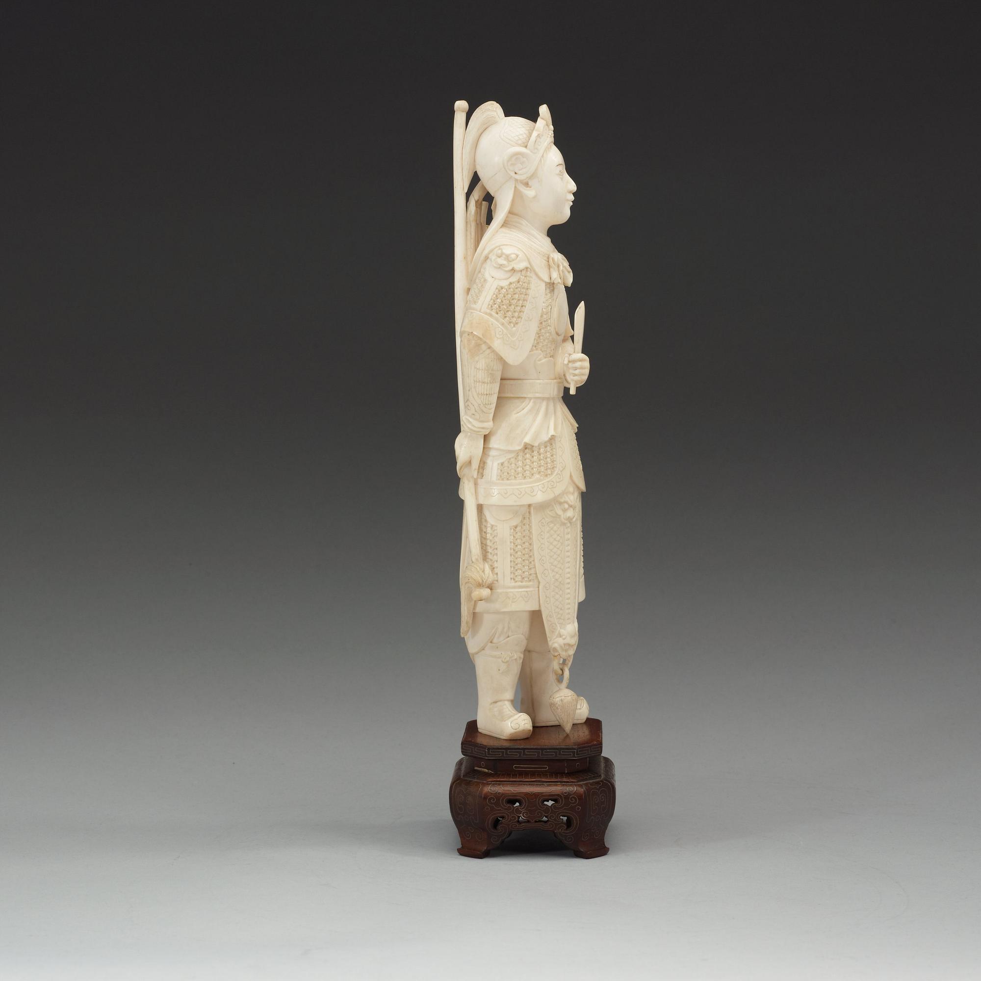 A carved ivory figure of a soldier in arms, late Qing dynasty, circa 1900.