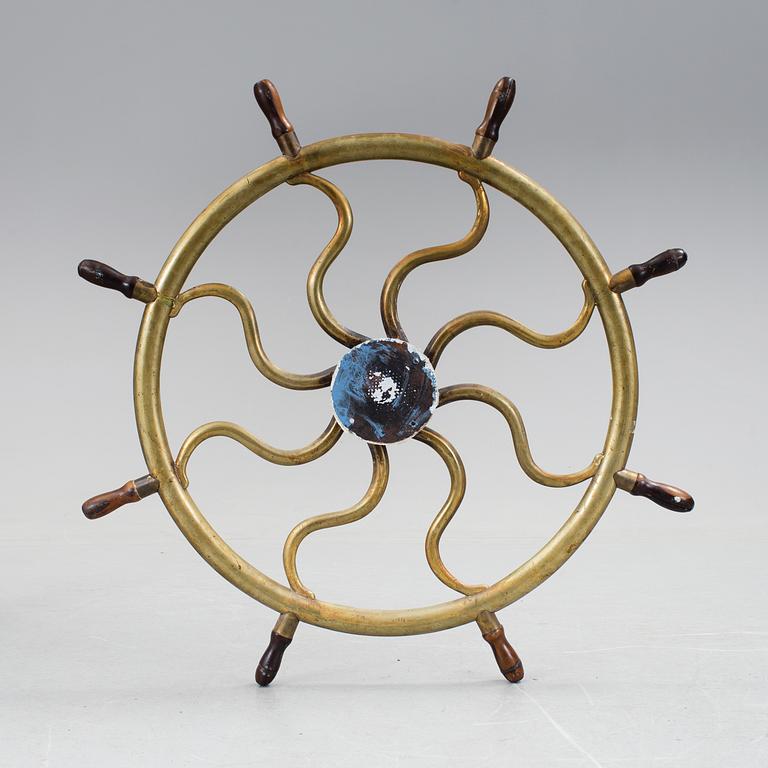 A ship steering wheel, about 1900.