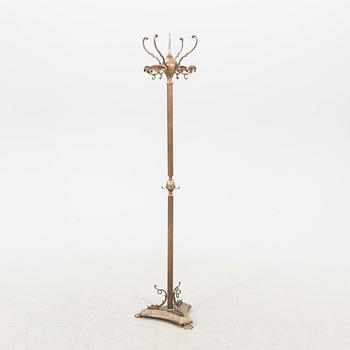 A brass coat hanger from the first half of the 20th century.