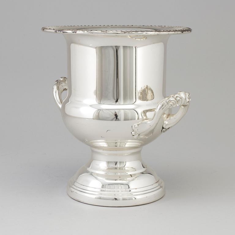 A 20TH CENTURY SILVERVED METAL CHAMPAGNE COOLER.