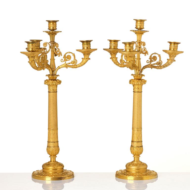 A pair of French Empire four-light gilt bronze candelabra, early 19th century.