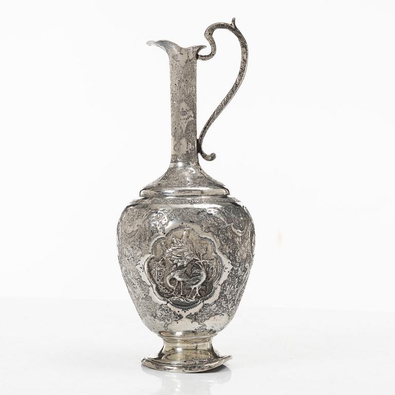 A Persian silver pitcher with five stemmed cups and a beaker, first part of the 1900s.