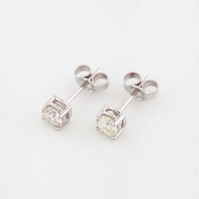 A pair of brilliant cut diamond earrings.