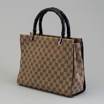 GUCCI, a monogram fabric hand bag and beauty bag.