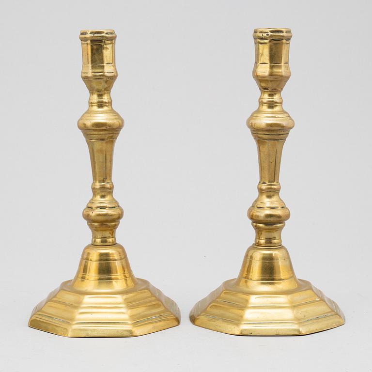 A pair of 18th century bronze candlesticks.