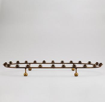 A mid 20th Century brass candle ring.