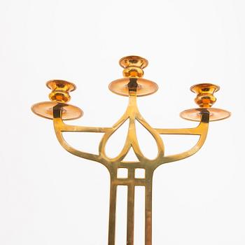 A öair of brass candelabras 20th century.