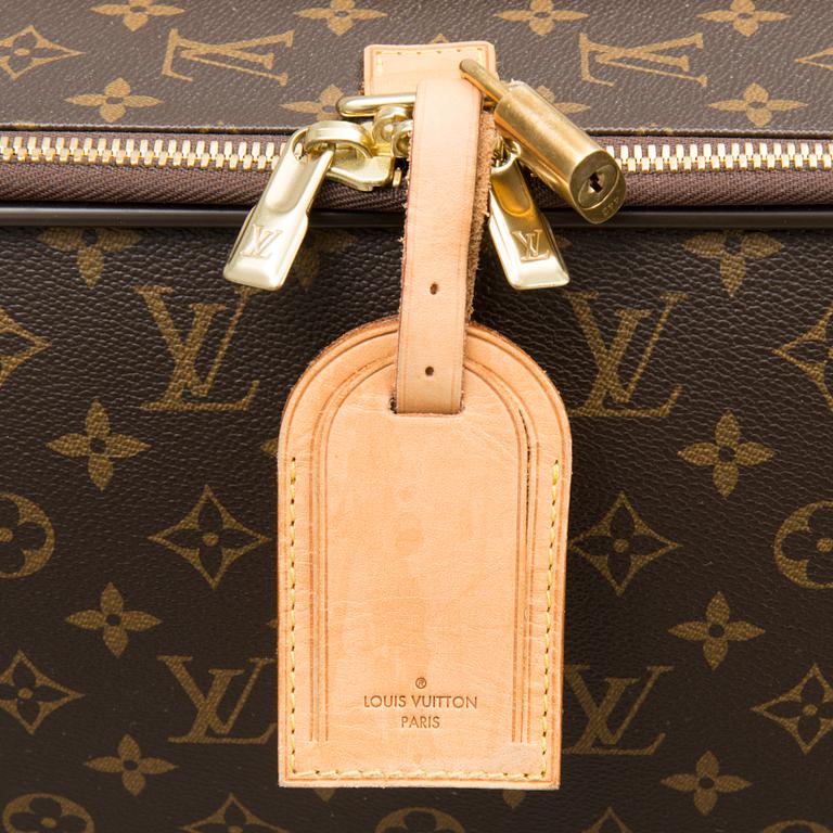 A Monogram Canvas Pégase 65 Suitcase with a Protective Cover.