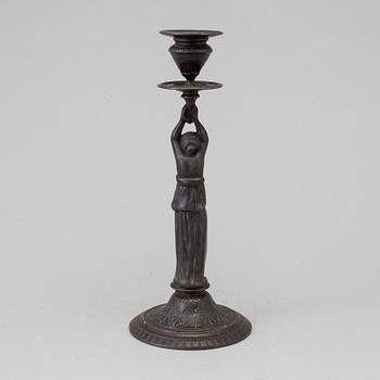 A 19th century iron candlestick marked F.L Vombach Offenbach A/M.