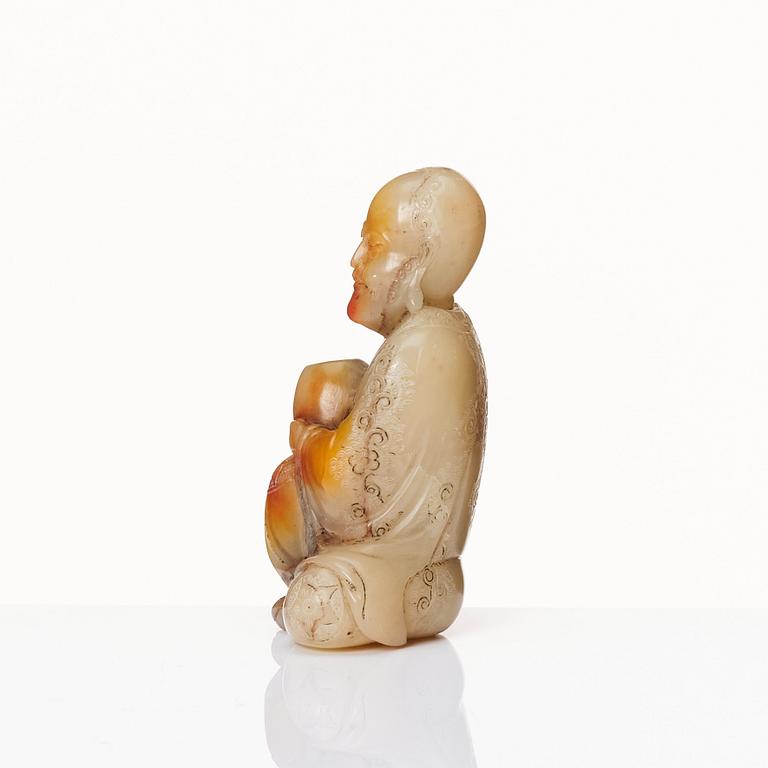 A Chinese carved nephrite sculpture of a man, 20th Century.