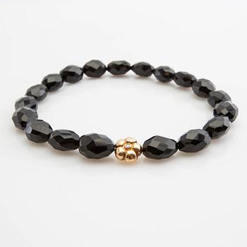 Ole Lynggaard, clasp, 18K gold with a round brilliant-cut diamond, and two necklaces.