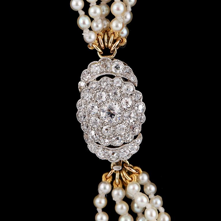 Diamond clasp cultured pearl necklace five rows.