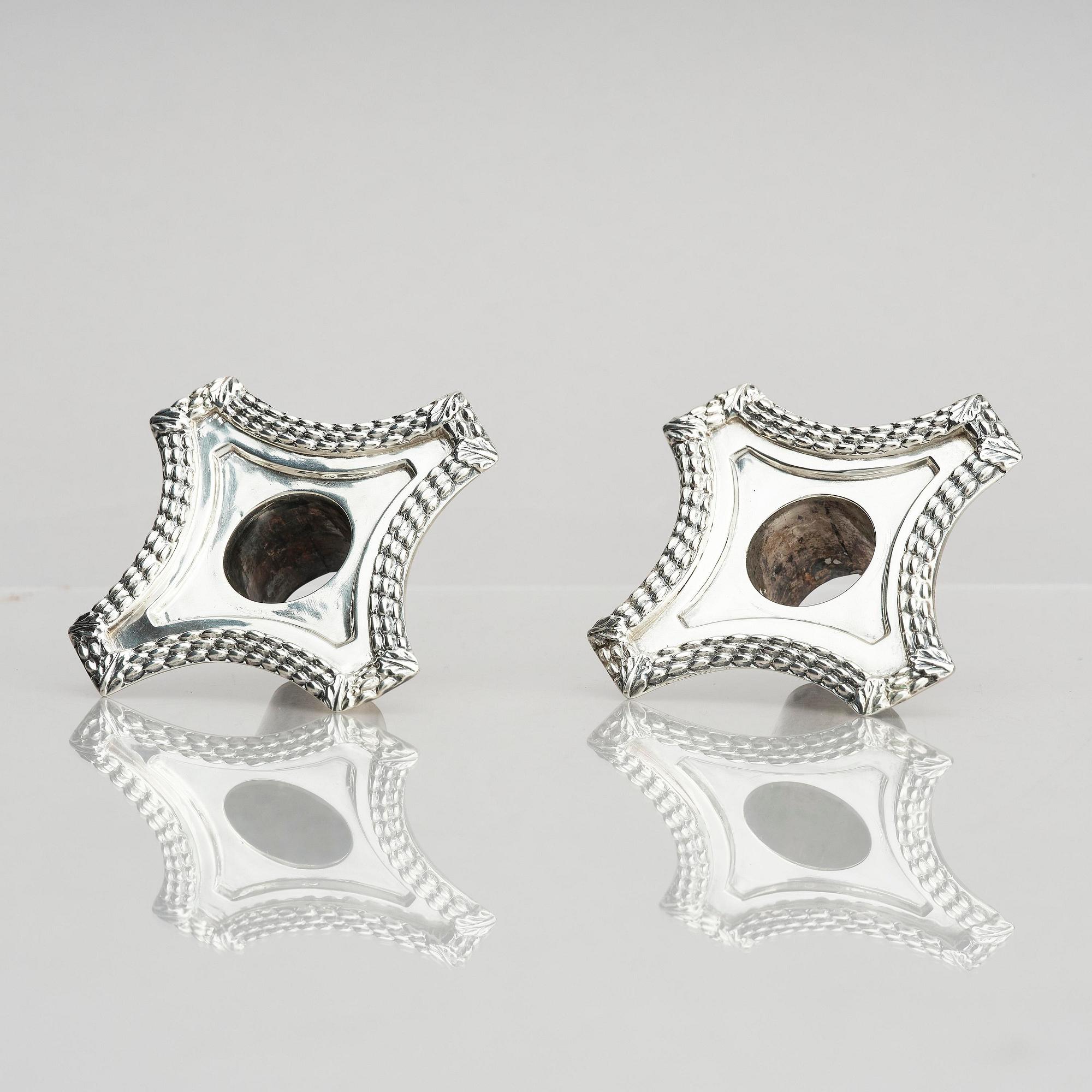 A pair of 18th century silver candlesticks, marks of Ebenezer Coker, London , possibly 1765.