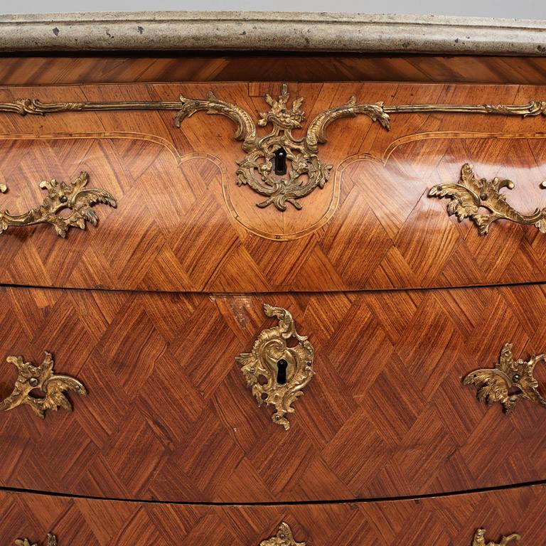 A rococo rosewood-veneered and ormolu-mounted commode by N. Korp (master 1763-1800).