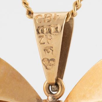 Necklace, 18K gold with synthetic white stone, in the shape of a bow.