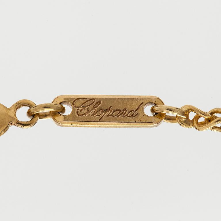 Chopard, an 18K gold 'Happy Diamonds' necklace with brilliant-cut diamonds.
