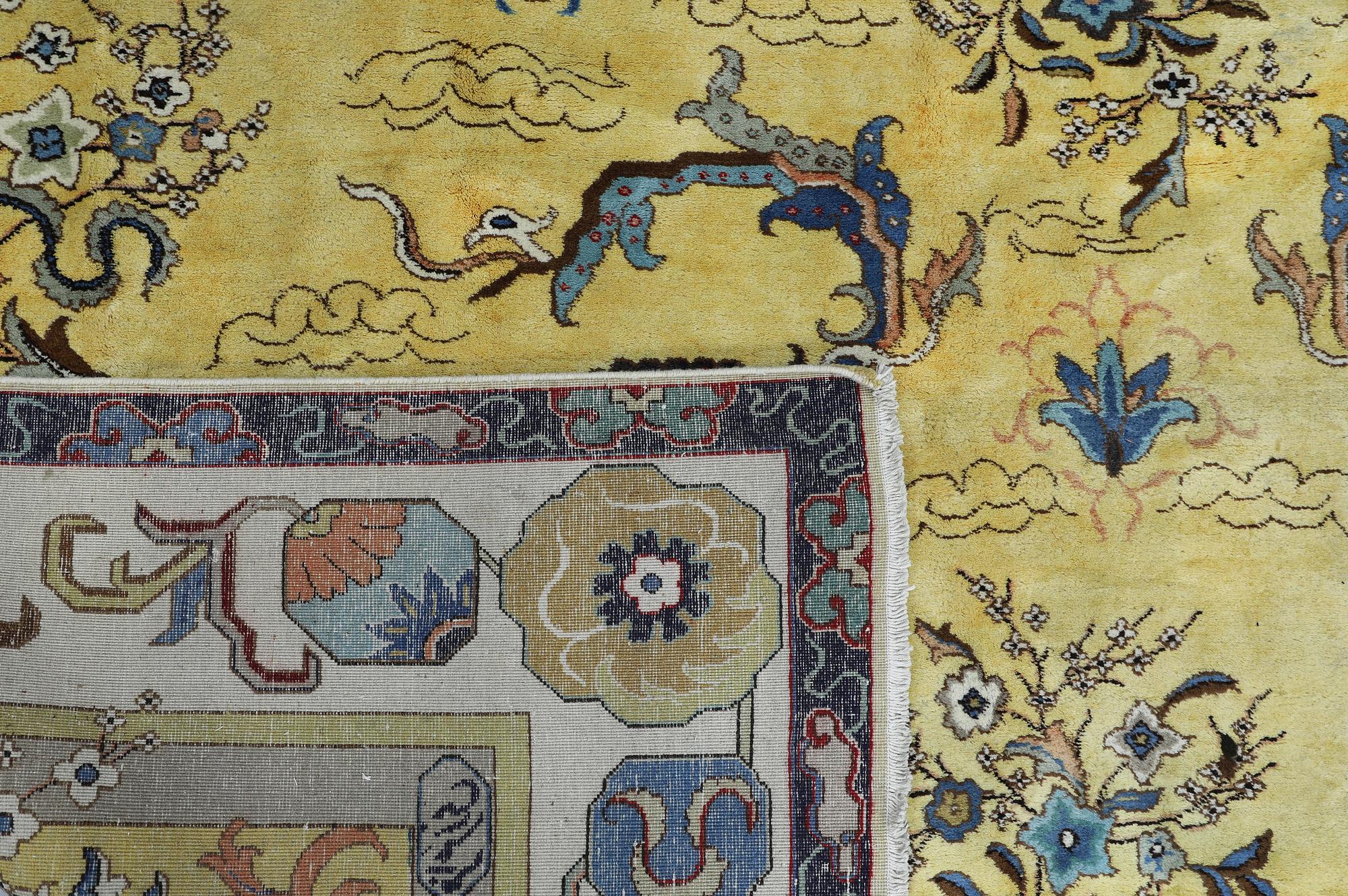A Tabriz carpet, signed, approx. 388 x 280 cm.