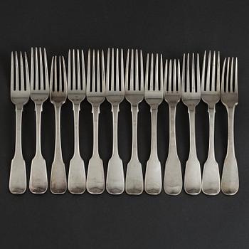 12 English silver forks mainly from the 19th century, some with unidentified crests.