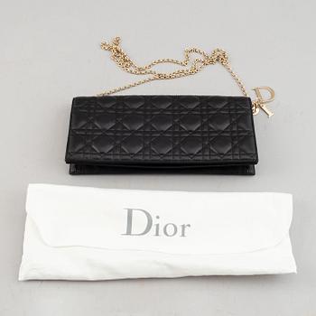 Christian Dior, a quilted leather handbag/clutch.