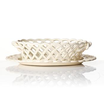 A latticed creamware chestnut basket with stand, 19th century.