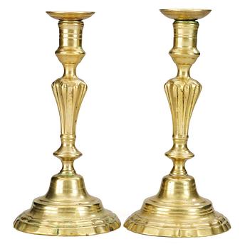 587. A pair of 18th century bronze candlesticks.