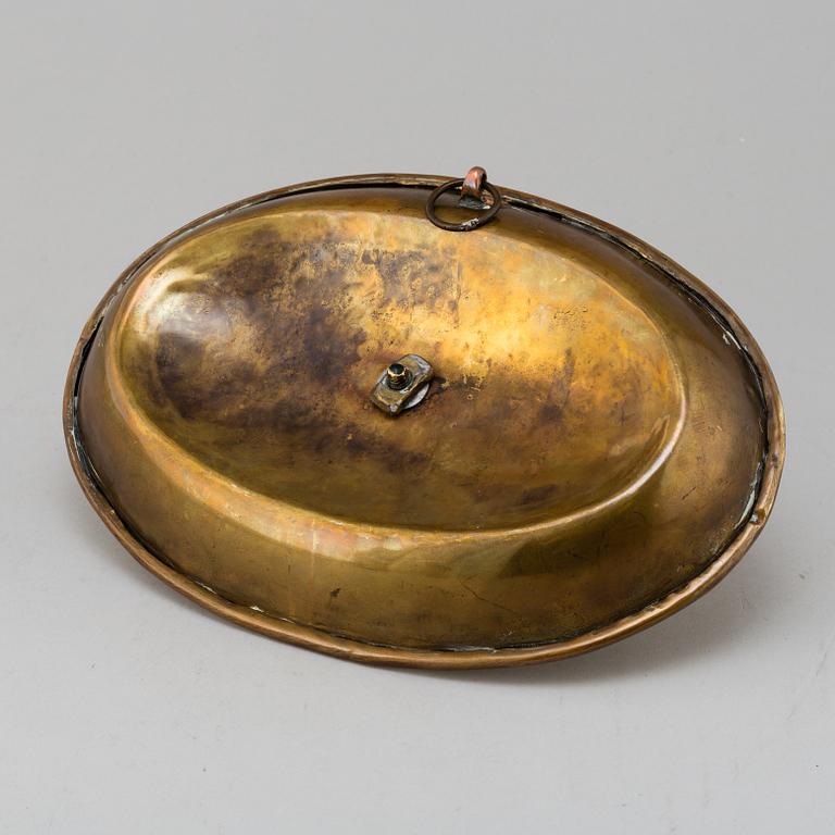 An 18th century brass candlestick.