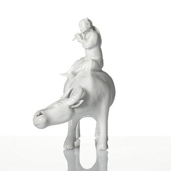 A blanc de chine figure of a boy on an ox, late Qing dynasty.