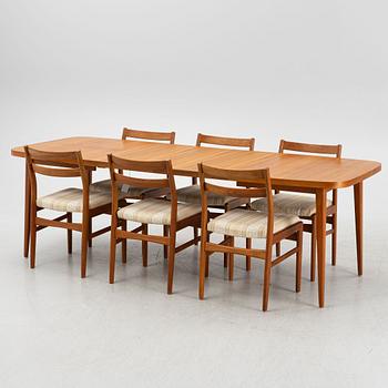 A dining table with six chairs, mid 20th century.